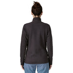 Back view of woman wearing black Patagonia R1 Air Fleece Zip-Neck showing full back detail