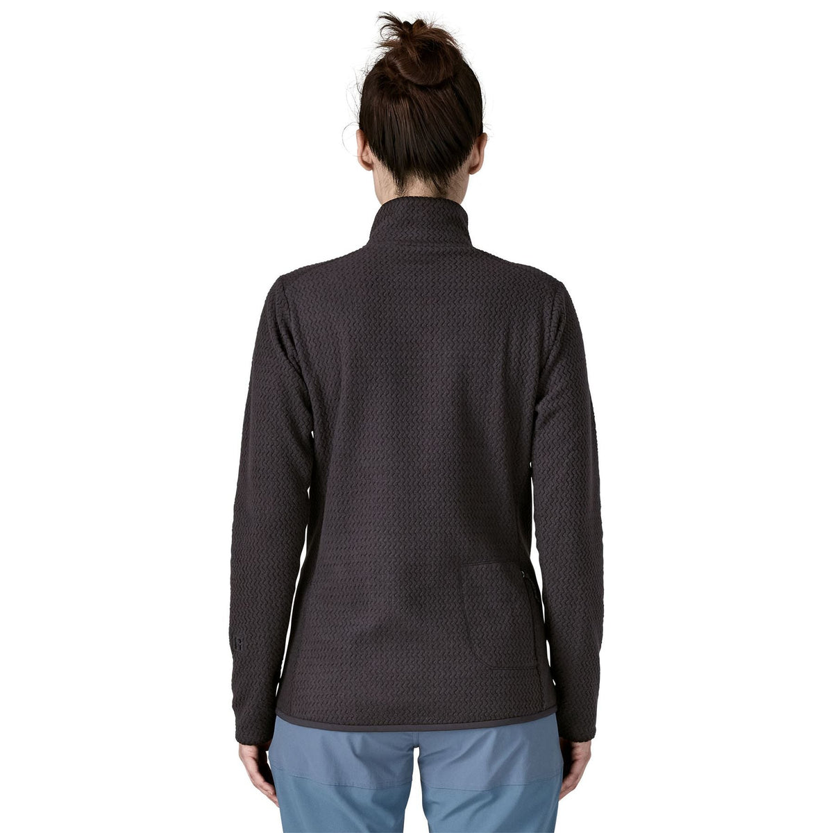 Back view of woman wearing black Patagonia R1 Air Fleece Zip-Neck showing full back detail