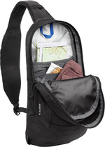 Black CamelBak Arete sling bag opened showing interior compartments and organization pockets
