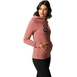 Woman wearing Fox Racing rose pink pullover hoodie with black fox logo