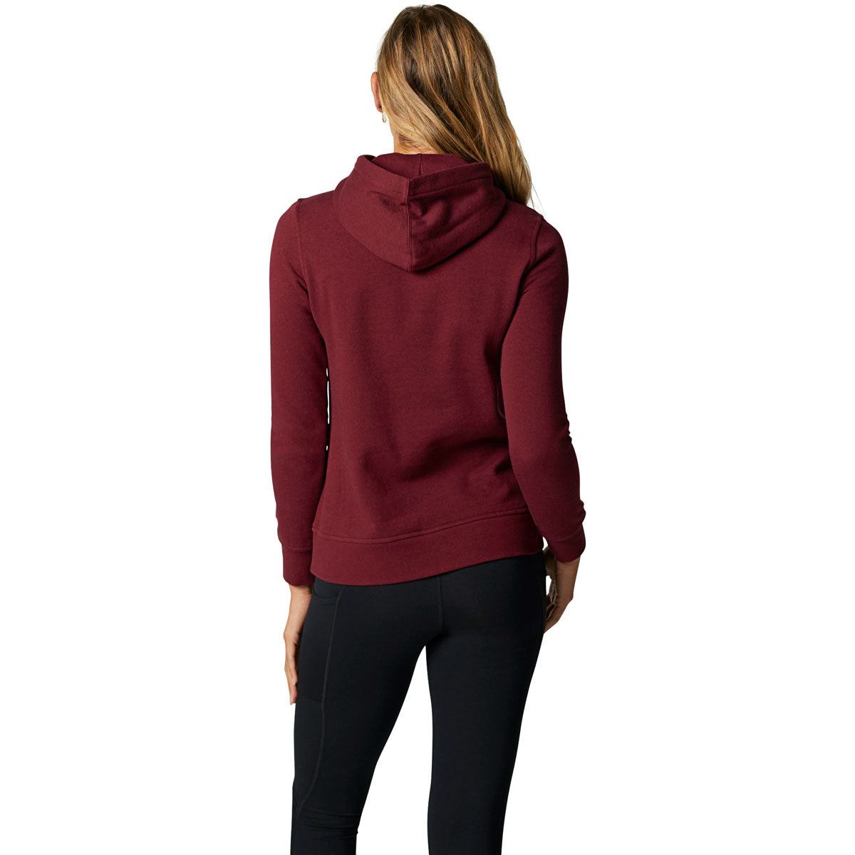 Back view of woman wearing cranberry Fox Racing pullover fleece hoodie with black pants