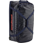 Patagonia Black Hole Wheeled Duffel 100L in black with navy blue straps