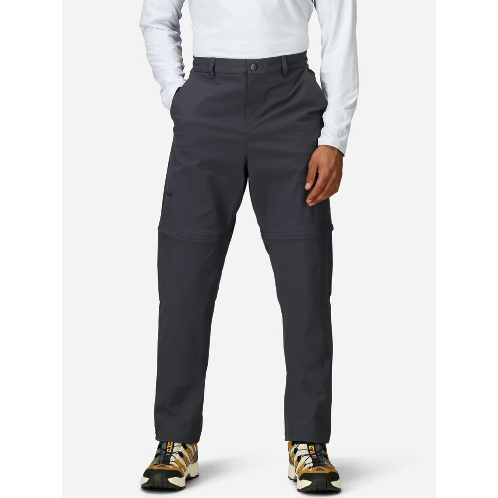 Man wearing dark gray Marmot convertible pants with white shirt and hiking shoes
