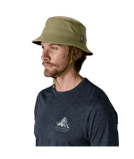 Man wearing Patagonia Surf Brimmer Hat in basin green with chin strap