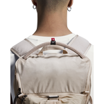 On Speed Pack 18L Lite cream backpack worn on model's back, rear view