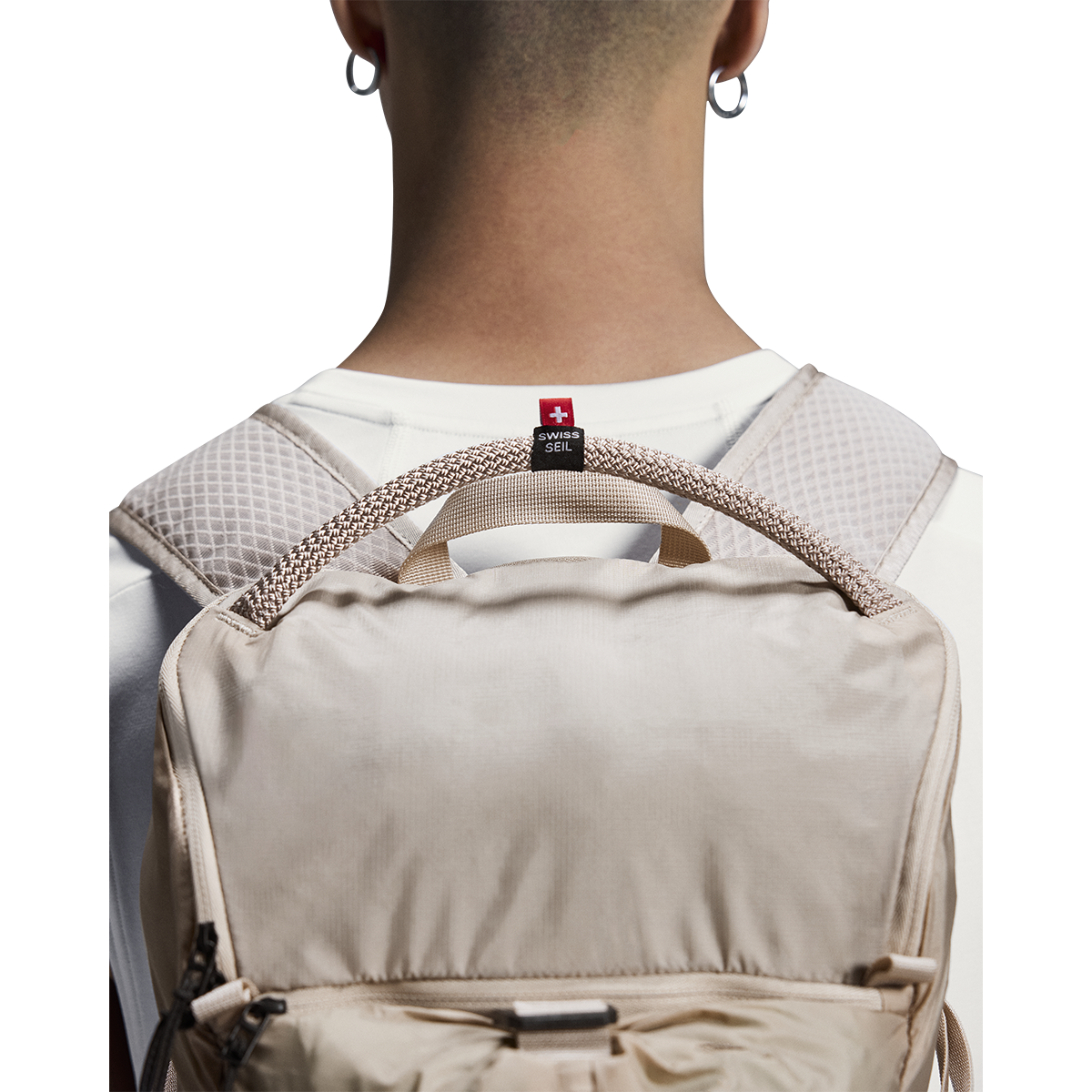 On Speed Pack 18L Lite cream backpack worn on model's back, rear view