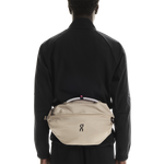 On Sling Pack 9L in Biscuit worn as crossbody bag on model's back
