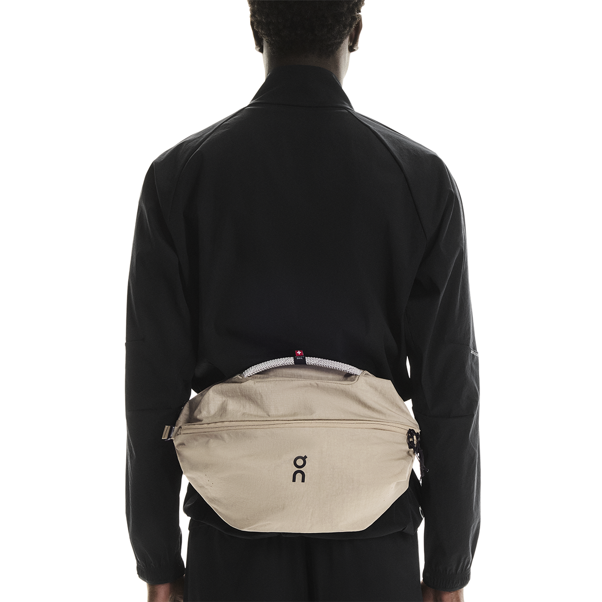 On Sling Pack 9L in Biscuit worn as crossbody bag on model's back