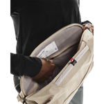 On Sling Pack 9L in Biscuit opened to reveal interior mesh compartments and Swiss Seil label