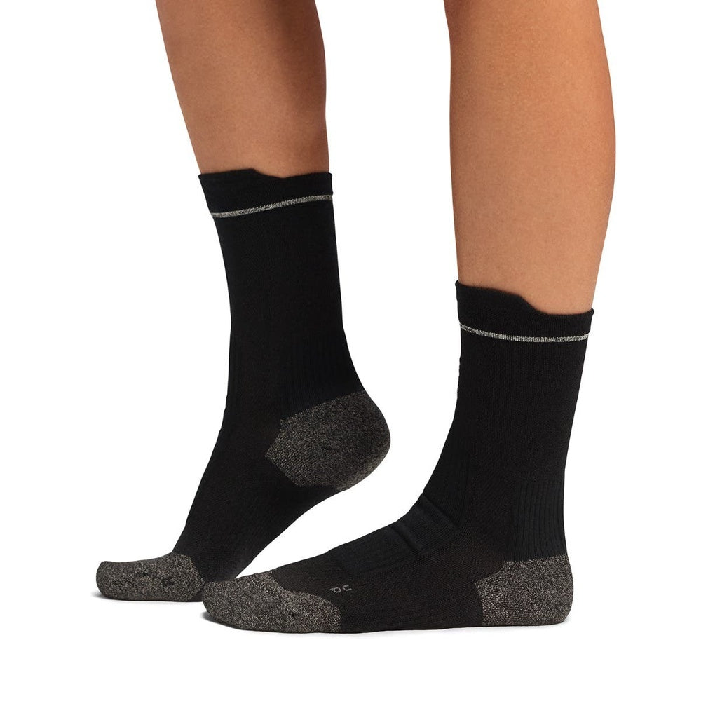 Black merino wool socks with grey heel and toe reinforcement on model legs