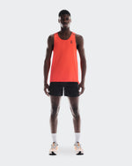 Man wearing bright orange On Performance Tank with black shorts and running shoes