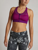 Woman wearing purple Brooks Fastforward zip-front sports bra with black floral leggings