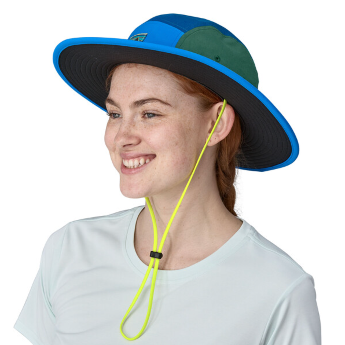 Woman wearing Patagonia Quandary Brimmer hat in blue and green colorblock design