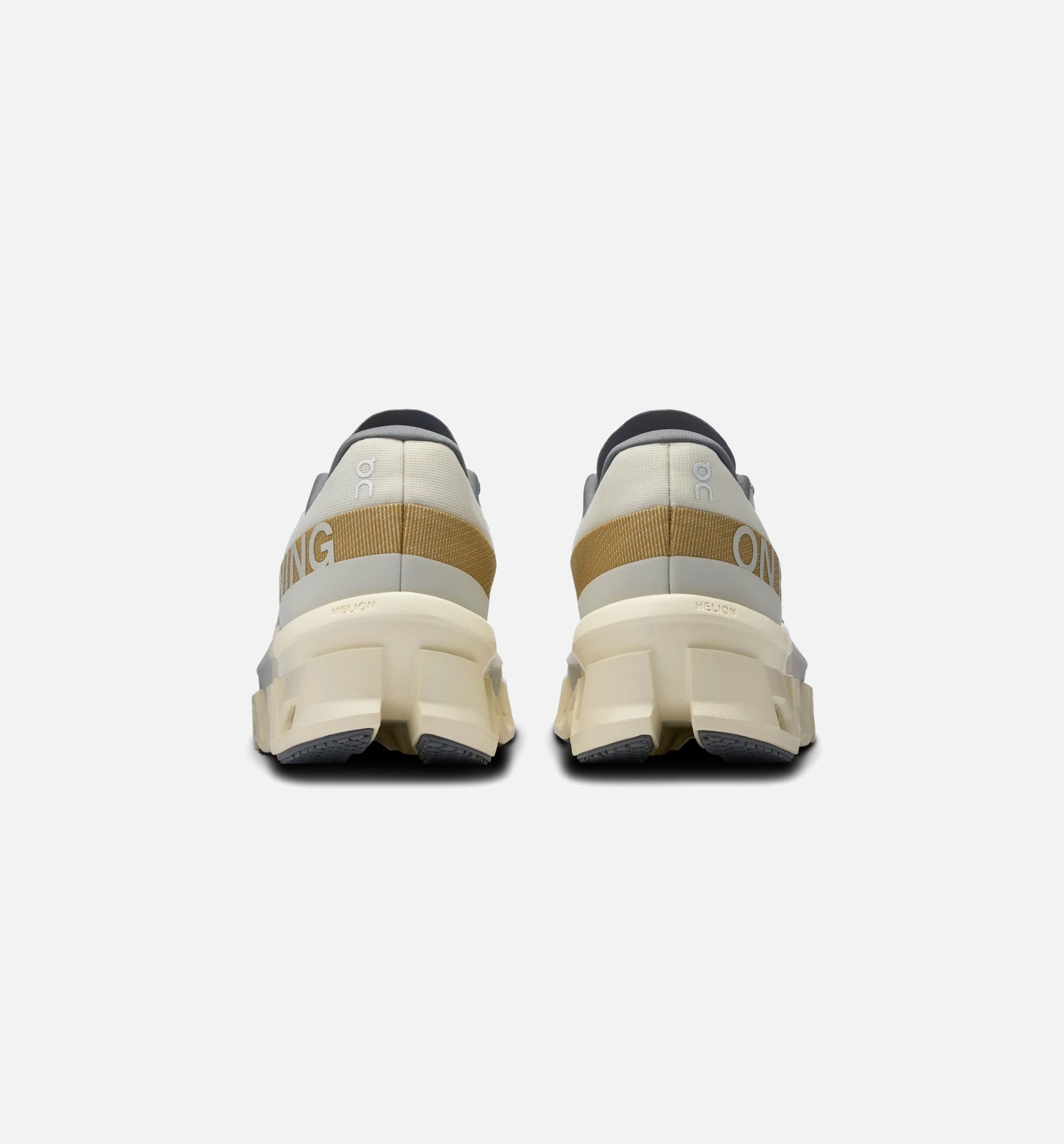 On Cloudmonster 2 running shoes in cream colorway viewed from behind