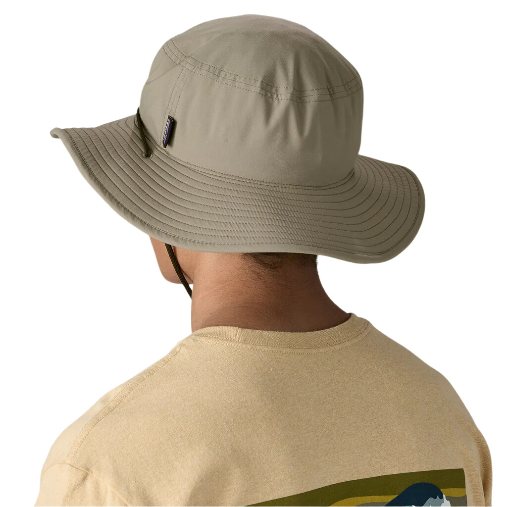 Person wearing Patagonia Brimmer Hat in sage green with wide brim