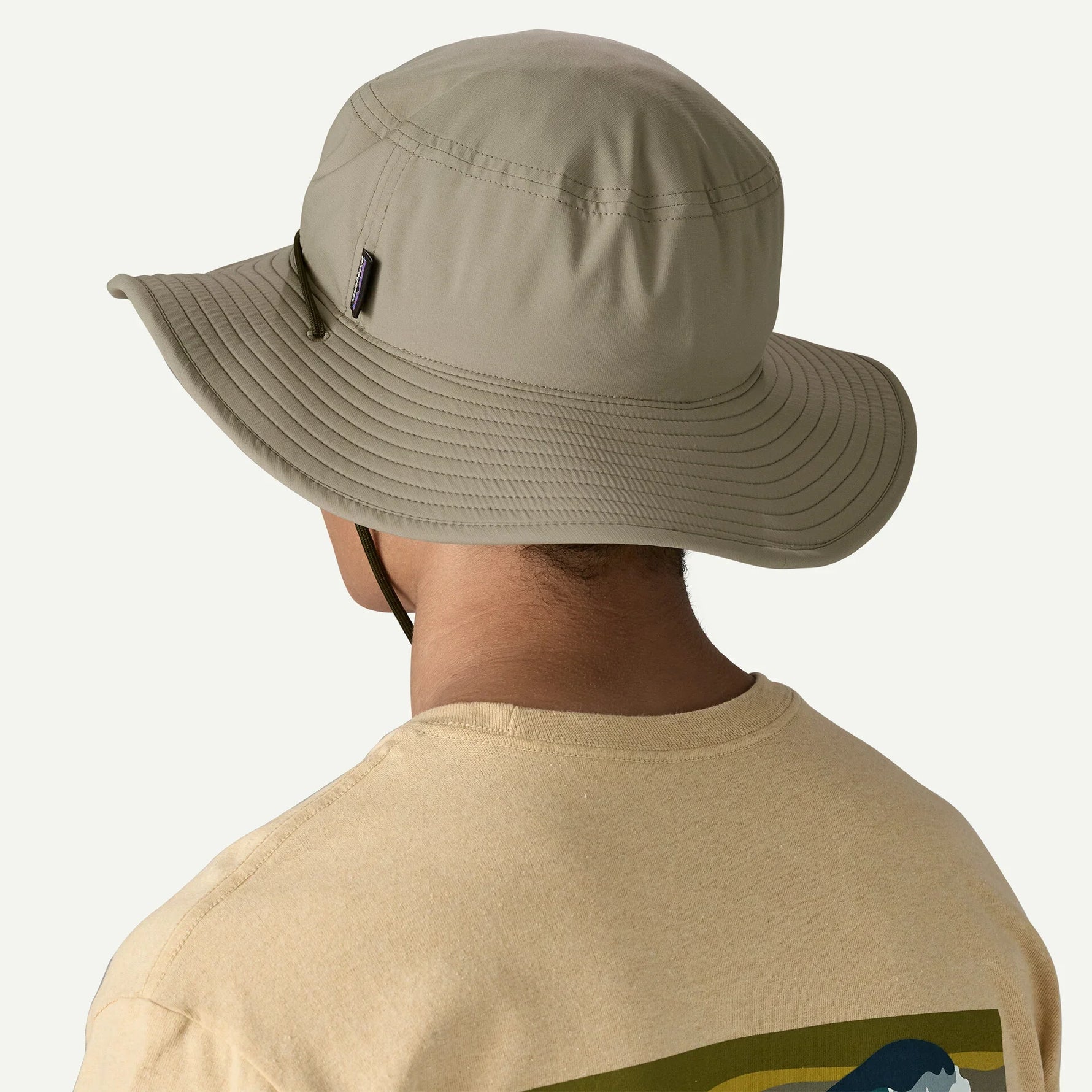 Person wearing Patagonia Brimmer Hat in sage green from behind showing wide brim