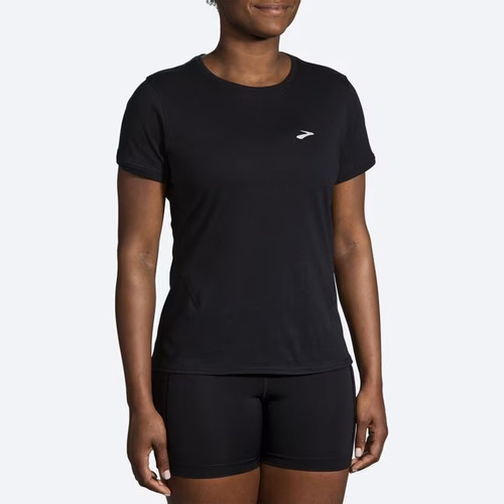 Woman wearing black Brooks Distance short sleeve running shirt with matching shorts