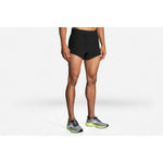Brooks Sherpa 3-inch Split Running Shorts in black worn by male model with Brooks running shoes