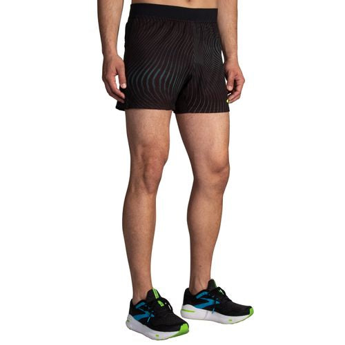 Brooks Sherpa 5-inch men's running shorts in black with teal wave pattern on model
