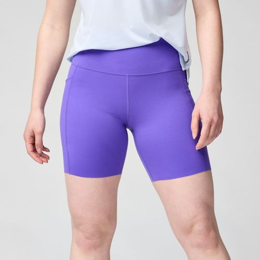 Woman wearing purple Brooks Chaser 7-inch athletic shorts with white top