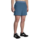 Brooks Sherpa 7 inch 2-in-1 running shorts in teal blue color on male model