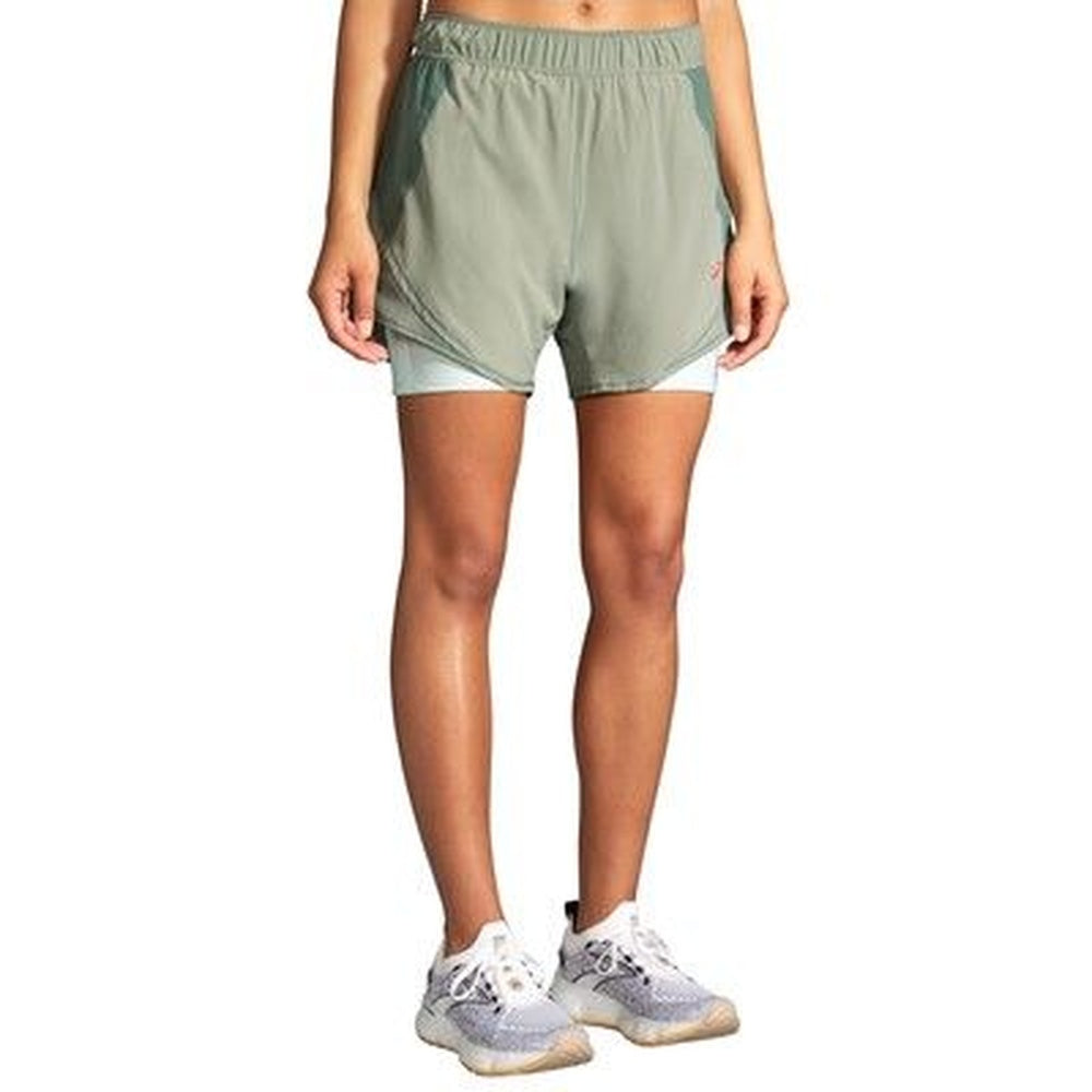 Brooks Chaser 5-inch 2-in-1 women's running shorts in pebble green colorway on model