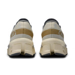 On Cloudmonster 2 running shoes in cream color with gold details, rear view