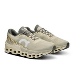 On Cloudmonster 2 running shoes in cream and olive green colorway