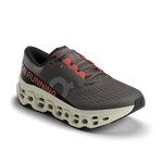 On Cloudmonster 3 running shoe in dark gray with coral accents and distinctive perforated sole