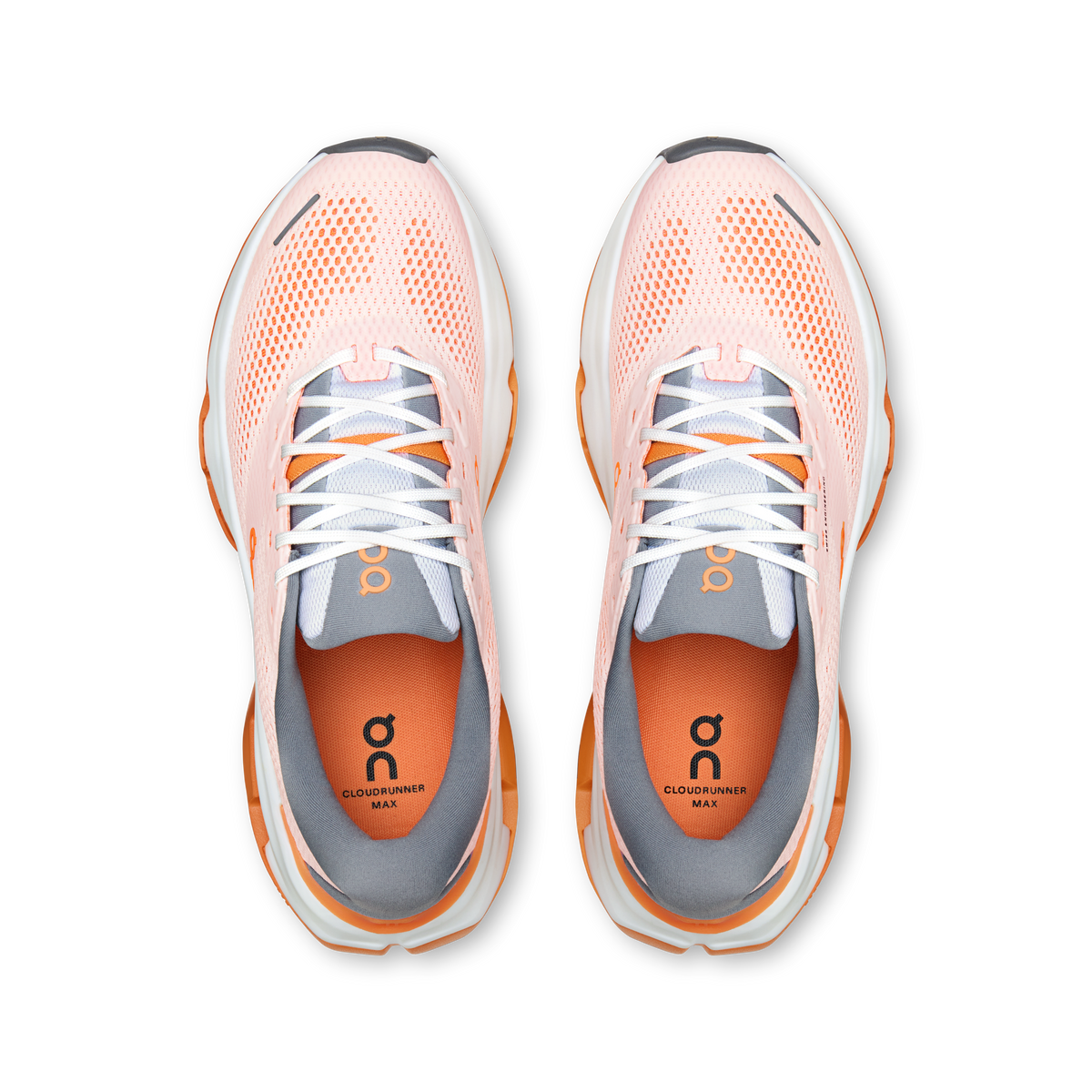 On Cloudrunner Max pair of running shoes top-down view showing pink mesh upper and orange insole