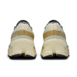 On Cloudmonster 2 running shoes in cream colorway, rear view showing chunky sole