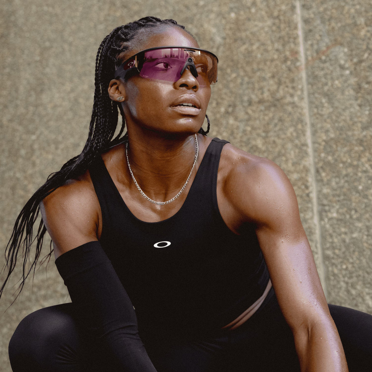 Athletic woman wearing Oakley Meta Vanguard sunglasses with black frame and pink Prizm lenses