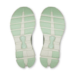 On Cloud X 4 running shoe soles in mint green and cream colorway