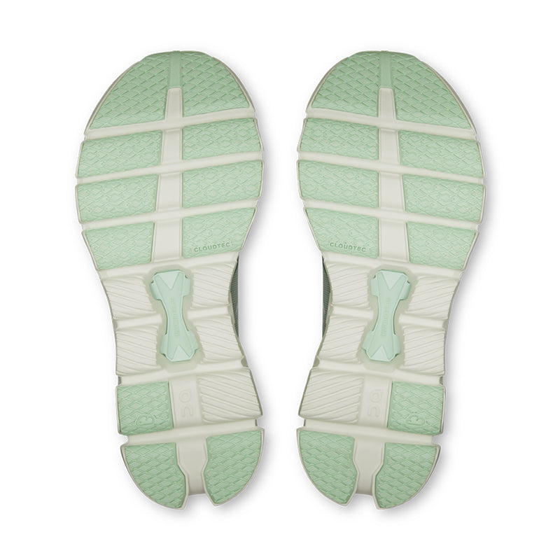 On Cloud X 4 running shoe soles in mint green and cream colorway