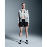 Woman wearing black On 3 Core Shorts with light jacket and sneakers
