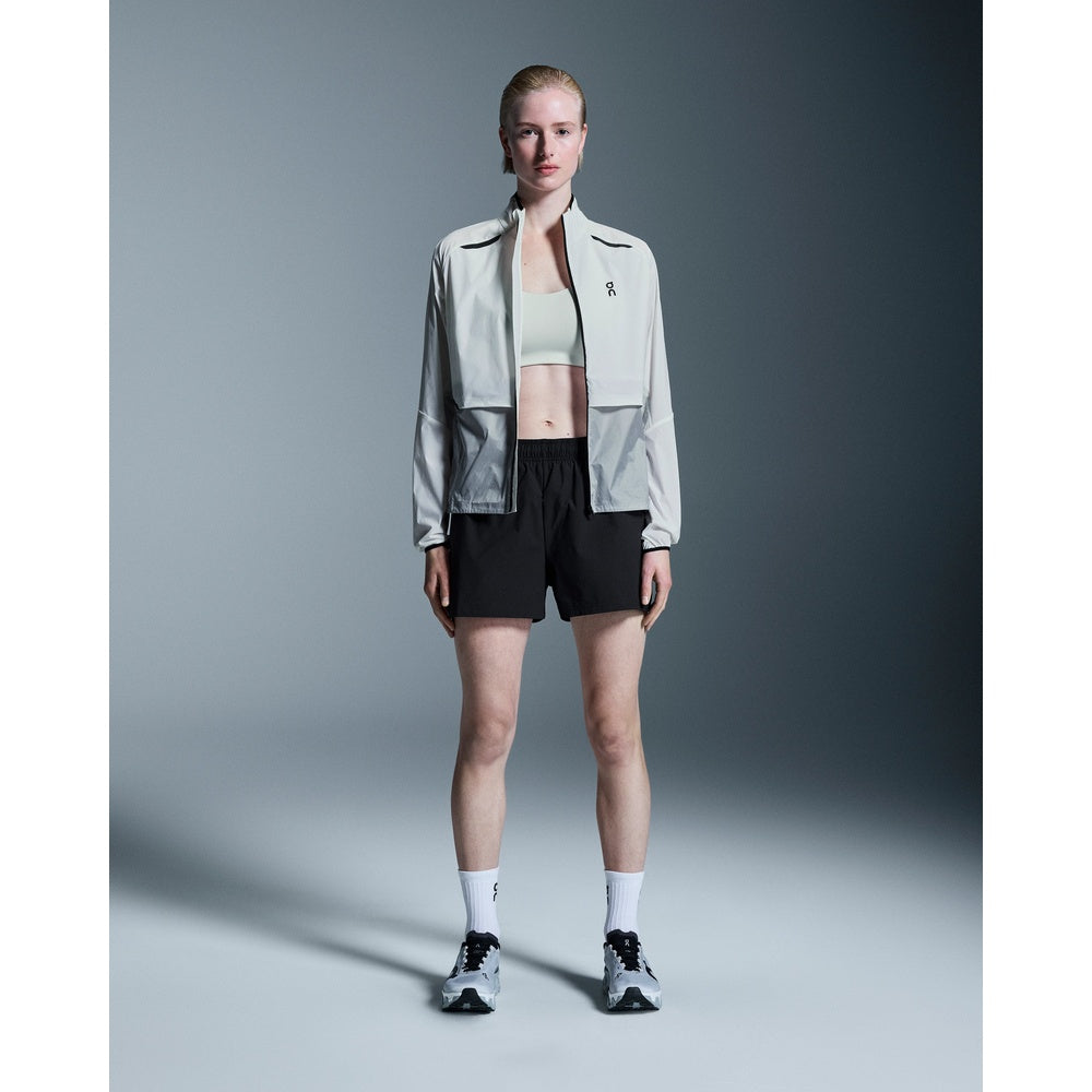 Woman wearing black On 3 Core Shorts with light jacket and sneakers