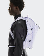 Model wearing On Speed Pack 18L LiteMagnet backpack in thistle purple color