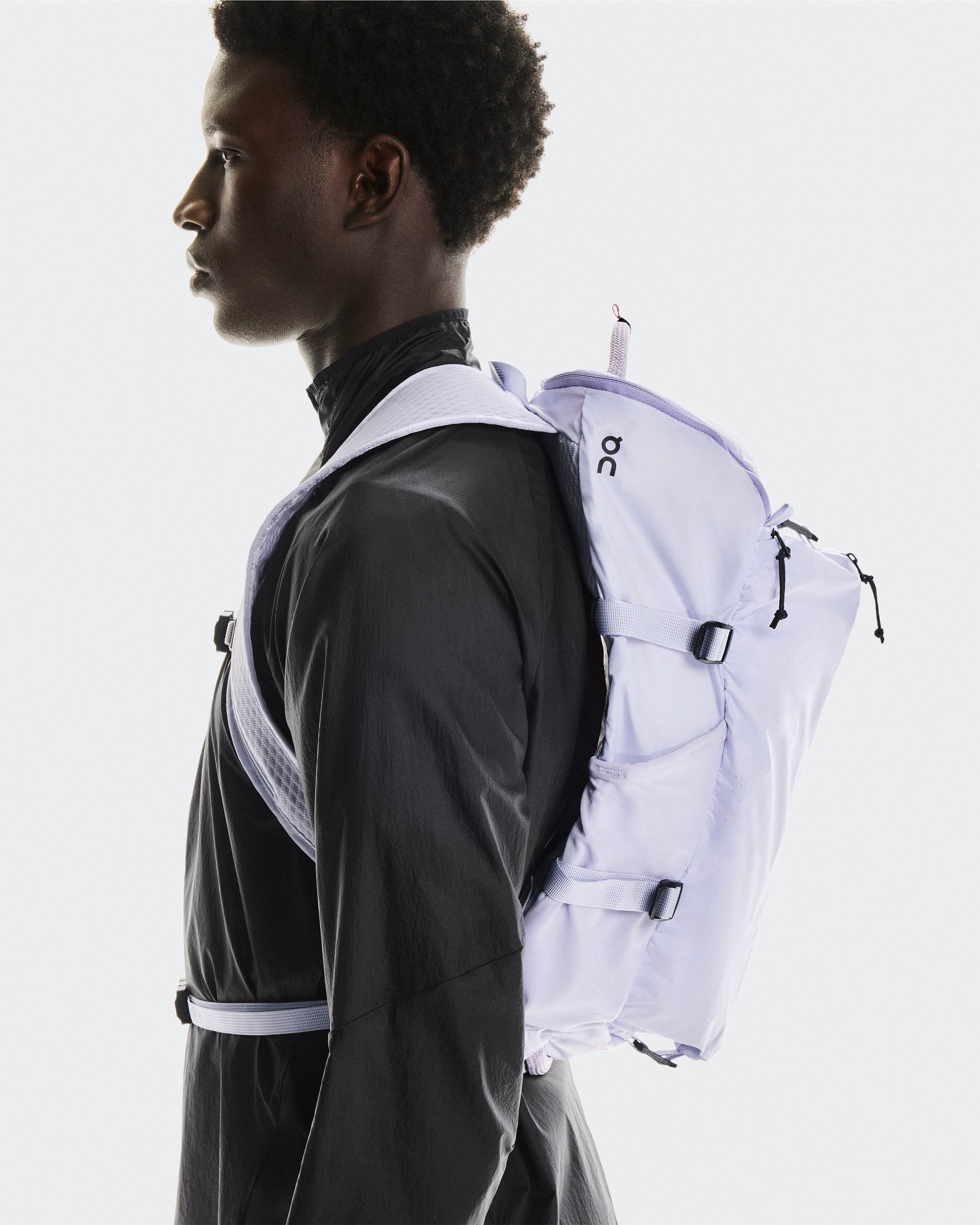 Model wearing On Speed Pack 18L LiteMagnet backpack in thistle purple color