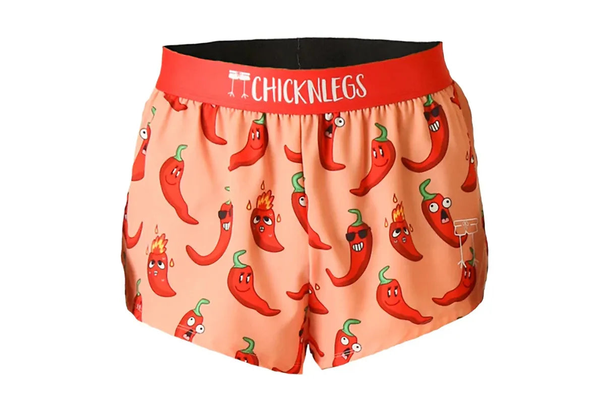 Chicknlegs coral athletic shorts with cartoon red chili pepper pattern and red waistband