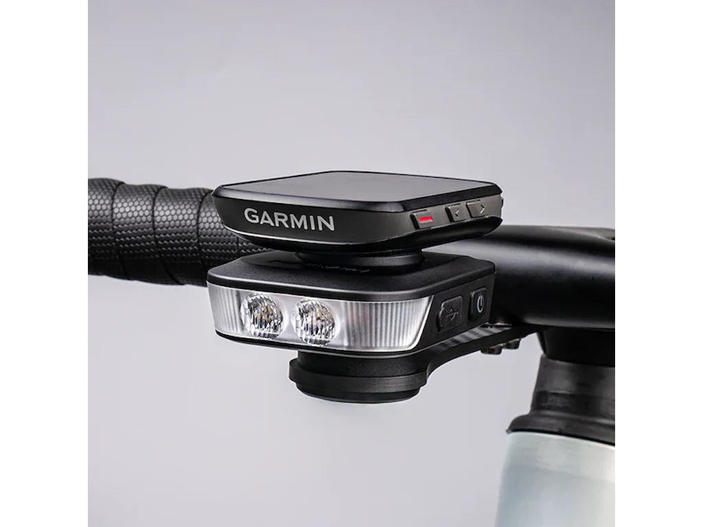 Ravemen FR1100 front light mounted on handlebar with Garmin Edge GPS unit stacked on top