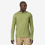 Man wearing Patagonia green hooded long-sleeve shirt against white background