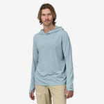 Man wearing light blue Patagonia hooded long sleeve shirt with khaki pants