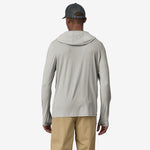 Back view of man wearing Patagonia gray-green hooded long sleeve shirt with trucker cap