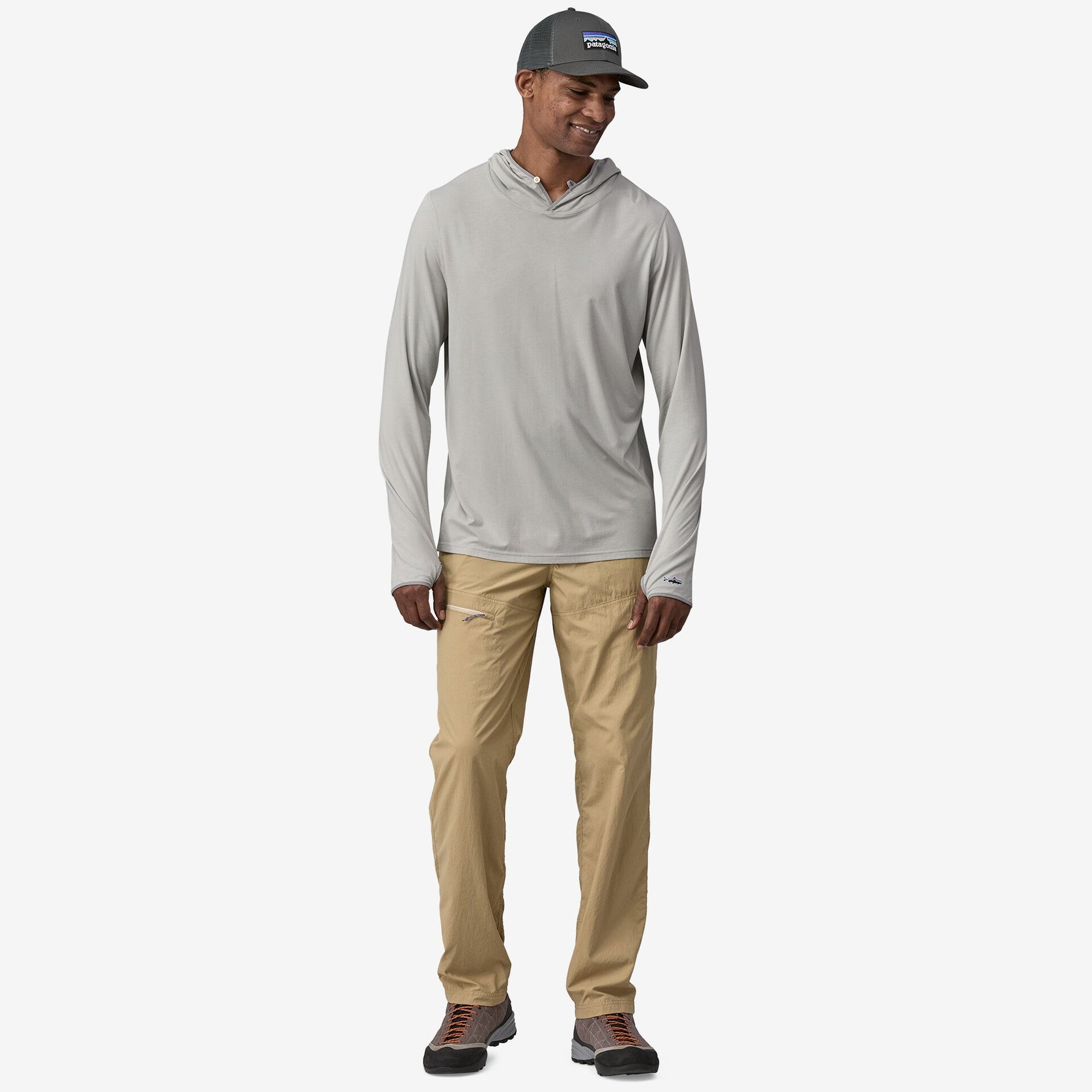 Man wearing Patagonia gray-green hooded long sleeve shirt with khaki pants