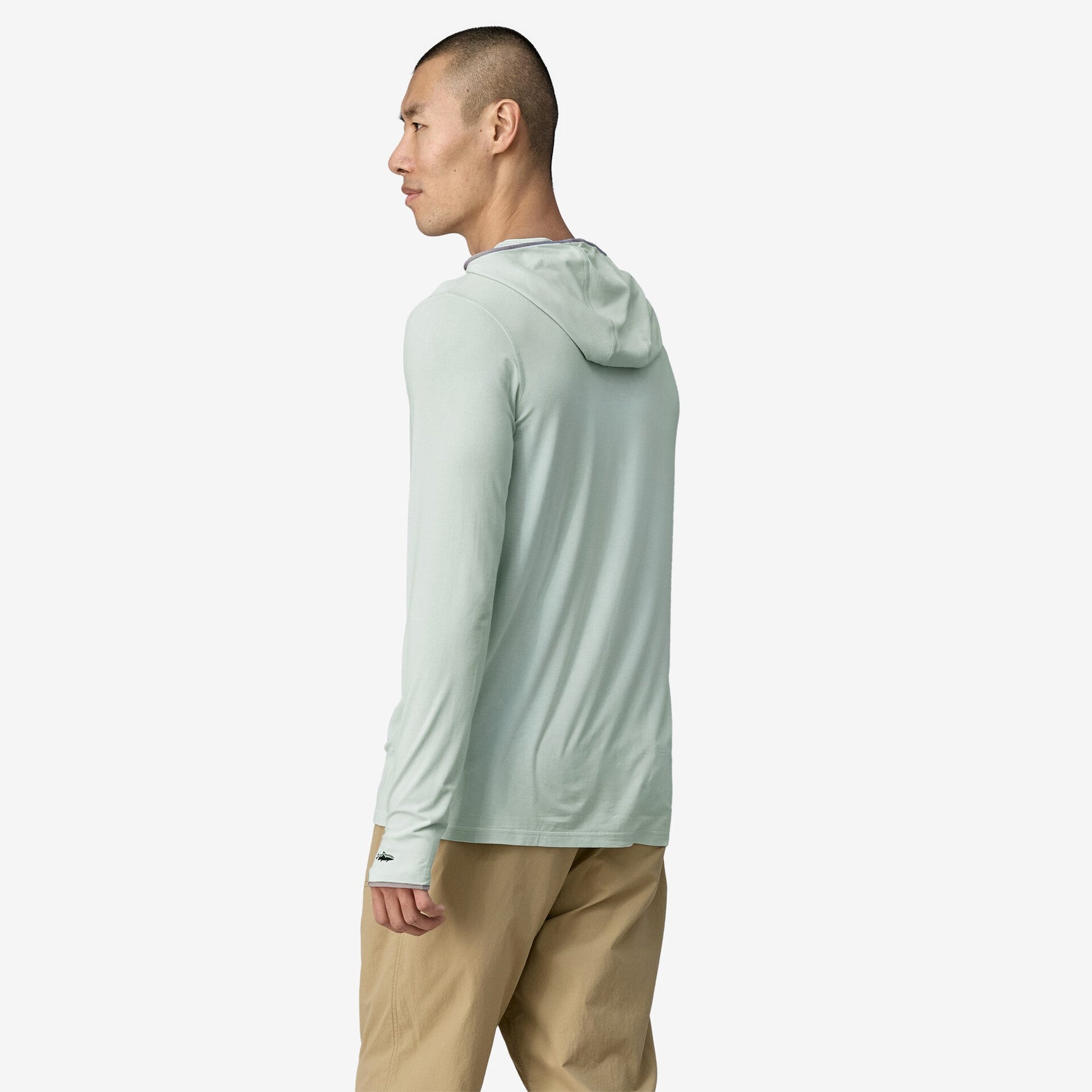 Man wearing Patagonia light green hooded long-sleeve shirt against white background