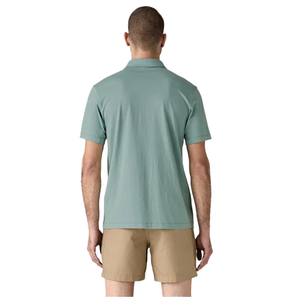 Back view of man wearing sage green Patagonia polo shirt with khaki shorts