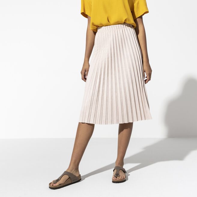 Birkenstock Gizeh sandals in mocha brown worn by model with pleated skirt