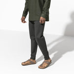 Birkenstock Gizeh sandals in mocha brown worn by model on clean studio background