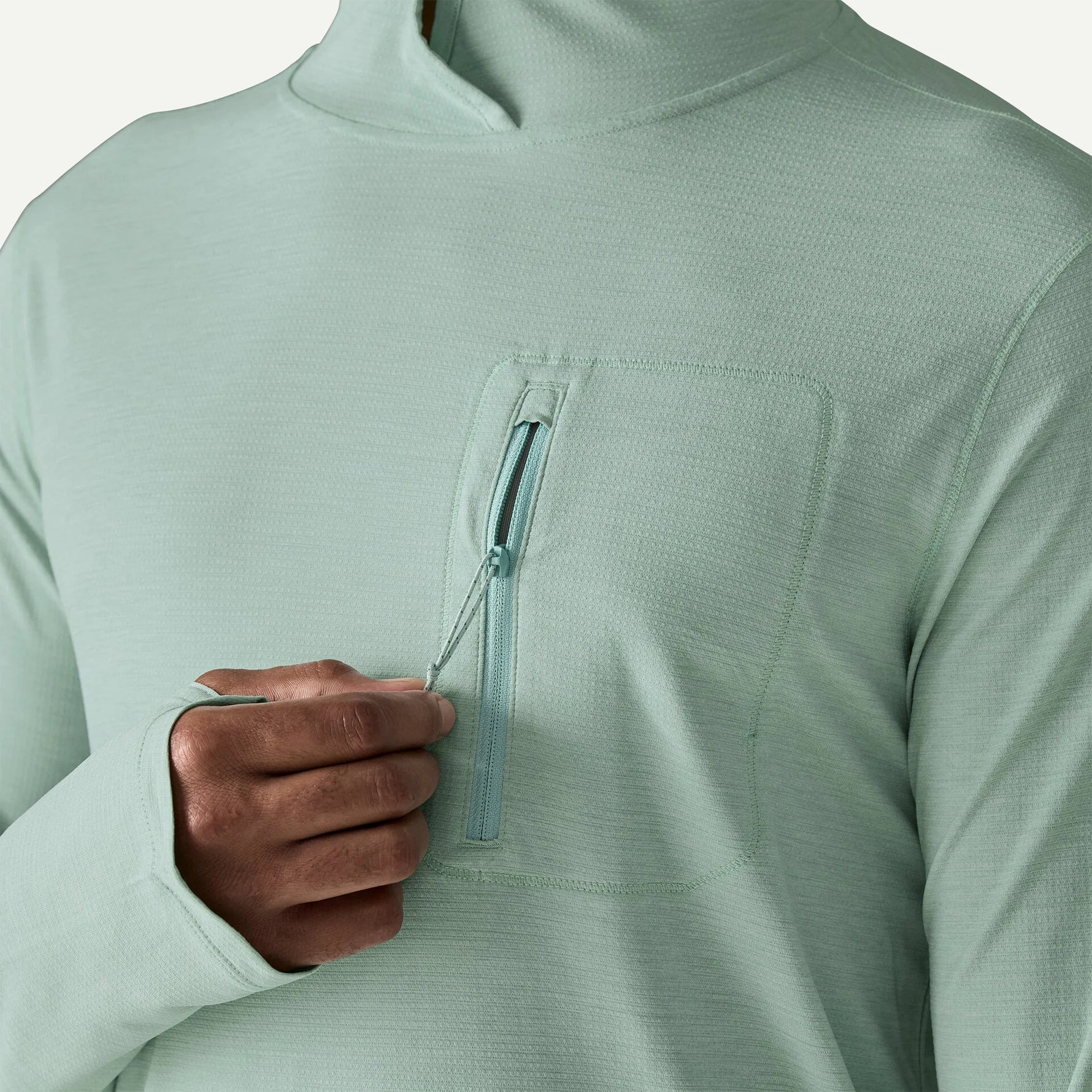 Patagonia men's light green hooded sun shirt with chest pocket zipper detail