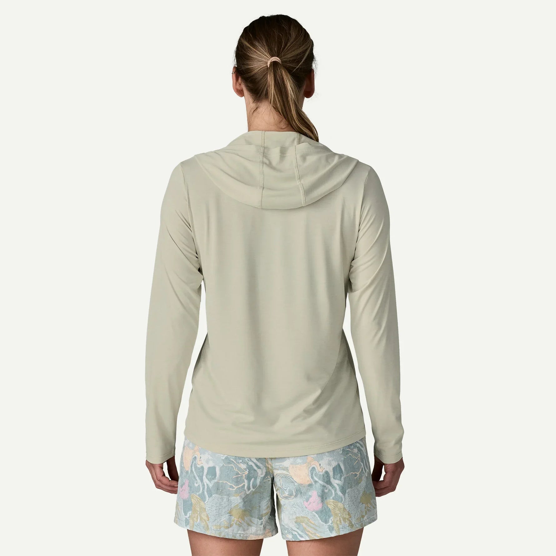 Back view of woman wearing Patagonia hooded long-sleeve shirt in sage green